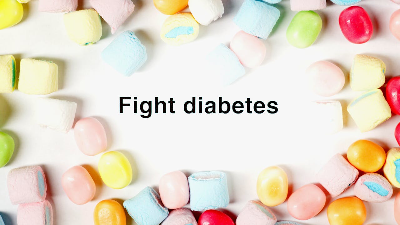 A border of colorful candies surrounds the message 'Fight diabetes' on a white background.