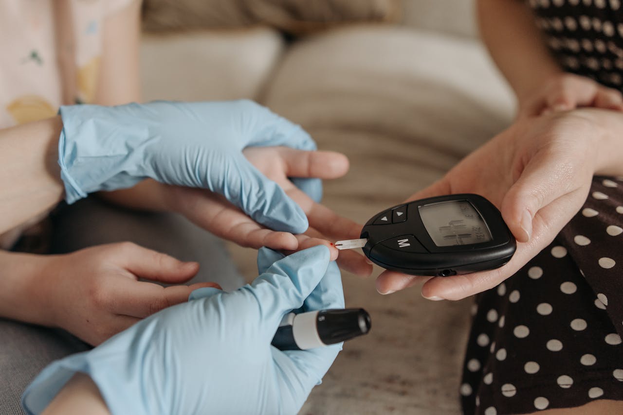 Hands measuring blood glucose levels with a glucose meter and test strip.